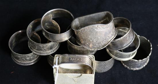 Eight assorted silver napkin rings and three plated napkin rings.